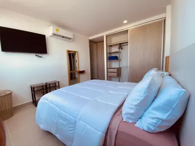a bedroom with a large bed with blue pillows at Premium Hub 1304 APARTAMENTO CARTAGENA Vista al Mar in Cartagena de Indias