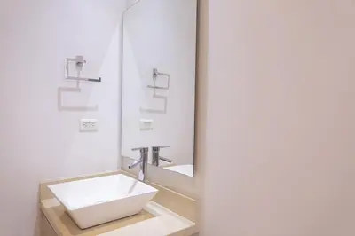 a bathroom with a sink and a mirror at Murano Elite by MOME in Cartagena de Indias