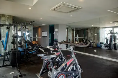 a gym with several tread machines and a mirror at Murano Elite by MOME in Cartagena de Indias