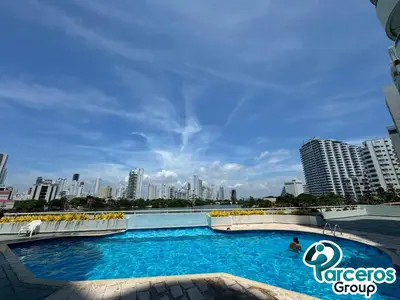 a large swimming pool with a city skyline in the background at Apartamentos Torres Del Lago Por Parceros Group in Cartagena de Indias