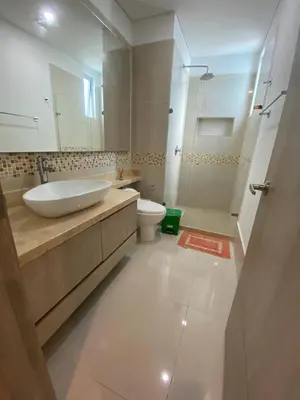 a bathroom with a sink and a toilet and a mirror at Apartamentos Palmetto Sunset por Parceros Group in Cartagena de Indias