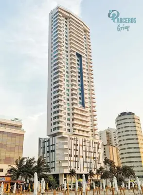 a tall building with a bunch of umbrellas in front of it at Apartamentos Palmetto Sunset por Parceros Group in Cartagena de Indias