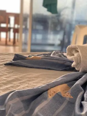a blanket laying on top of a bed at Hotel Los Chamos Barú in Cartagena de Indias
