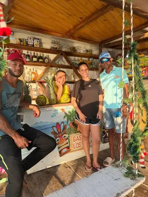 a group of people standing in front of a store at Hotel Los Chamos Barú in Cartagena de Indias