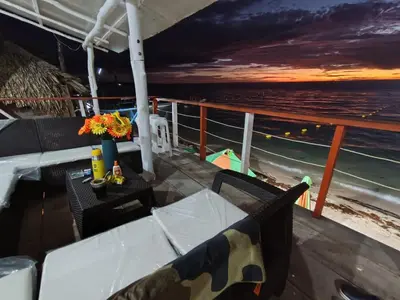 a balcony with a table and chairs on a cruise ship at Hotel Los Chamos Barú in Cartagena de Indias
