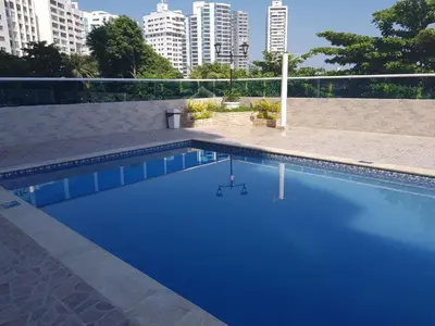 a blue swimming pool with buildings in the background at Balcon y Vista al Mar in Cartagena de Indias