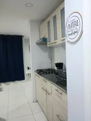 a kitchen with wooden cabinets and a counter top at Balcon y Vista al Mar in Cartagena de Indias