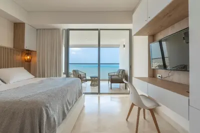 a bedroom with a bed and a view of the ocean at Seaside Serenity and Style in Cartagena de Indias