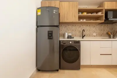 a refrigerator in a kitchen next to a dishwasher at Seaside Serenity and Style in Cartagena de Indias