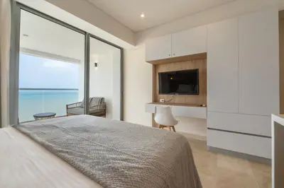 a bedroom with a large bed and a large window at Seaside Serenity and Style in Cartagena de Indias