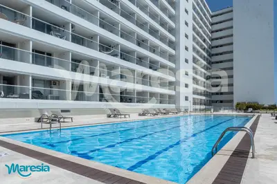 a swimming pool in front of a building at Seaside Serenity and Style in Cartagena de Indias