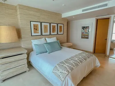 a bedroom with a large bed and a night stand at Hotel Radisson Residences Ocean Pavillion in Cartagena de Indias