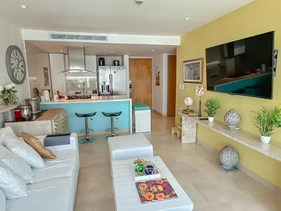 a living room with a couch and a kitchen at Hotel Radisson Residences Ocean Pavillion in Cartagena de Indias