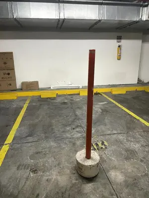 a red pole in the middle of a parking lot at Bluegardens Apartment, Central with Beautiful View in Barranquilla