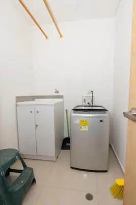 a small kitchen with a sink and a dishwasher at Bluegardens Apartment, Central with Beautiful View in Barranquilla