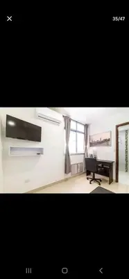 a living room with a piano and a desk at El Laguito Apartamento in Cartagena de Indias