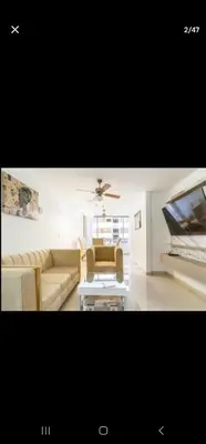 a living room with a couch and a table and a piano at El Laguito Apartamento in Cartagena de Indias