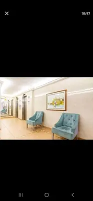 a room with two blue chairs and a couch at El Laguito Apartamento in Cartagena de Indias