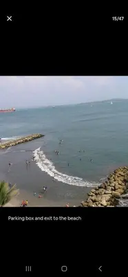 a picture of a beach with people in the water at El Laguito Apartamento in Cartagena de Indias