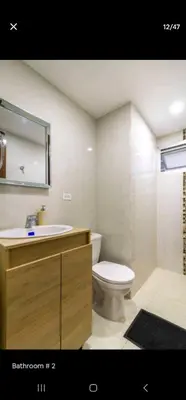 a bathroom with a sink and a toilet and a mirror at El Laguito Apartamento in Cartagena de Indias