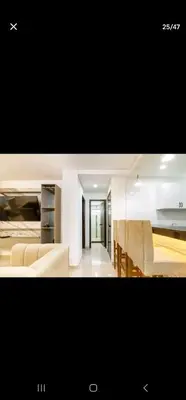 a kitchen and a living room with chairs and a table at El Laguito Apartamento in Cartagena de Indias
