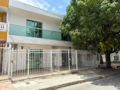 a white fence in front of a building at Maru apartamentos in Cartagena de Indias
