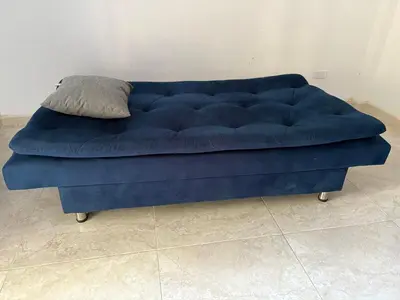 a blue couch with a pillow on top of it at Maru apartamentos in Cartagena de Indias