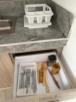 a drawer in a kitchen with utensils in it at Maru apartamentos in Cartagena de Indias