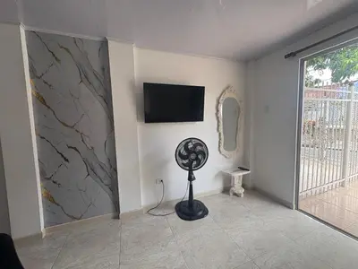 a room with a fan and a television on a wall at Maru apartamentos in Cartagena de Indias