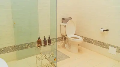 a bathroom with a toilet and a glass shower at Casa Niza - Colonial house in Cartagena de Indias