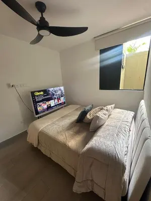 a bedroom with a bed and a flat screen tv at Luxury loft with home theater & pool, Buenavista top location in Barranquilla