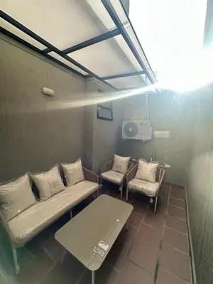 a room with a couch and two chairs and a table at Luxury loft with home theater & pool, Buenavista top location in Barranquilla