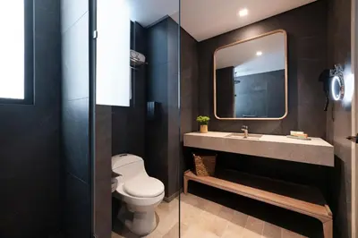 a bathroom with a toilet and a sink and a mirror at OZ Hotel Collection in Cartagena de Indias