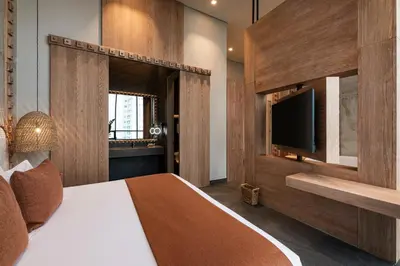 a bedroom with a large bed and a television at OZ Hotel Collection in Cartagena de Indias