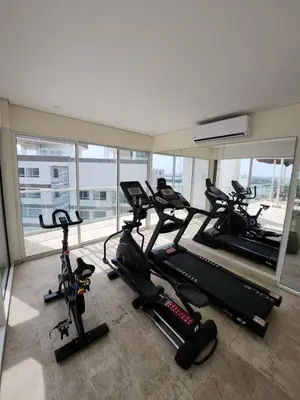 a gym with several treadmills and exercise bikes at Dominique 609 Apartment with private jacuzzi in Cartagena de Indias