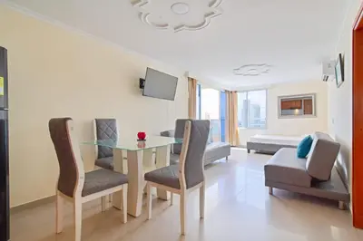 a living room with a glass table and chairs at Espectacular vista piso 20 in Cartagena de Indias