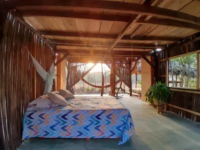 a bedroom with a bed in a room at Casa Surya - Cabaña sostenible en la naturaleza in San Onofre
