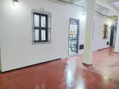 a white room with two barred windows and a brick floor at Agradable apto en el centro histórico in Cartagena de Indias