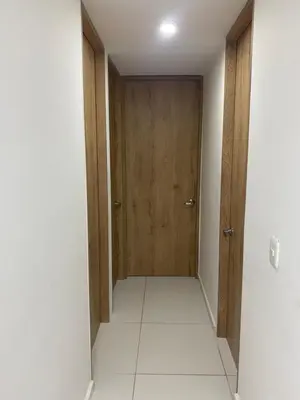 an empty hallway with a door and a tile floor at Apartamento alameda del Rio in Barranquilla