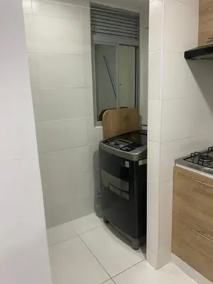 a small kitchen with a stove and a sink at Apartamento alameda del Rio in Barranquilla