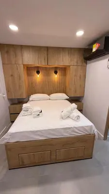 a bedroom with a large bed with two towels on it at Oasis Vista al Mar in Cartagena de Indias