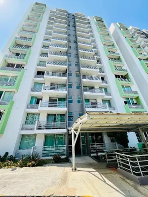 an apartment building with a parking lot in front of it at Apartamento en Sabanilla in Puerto Colombia