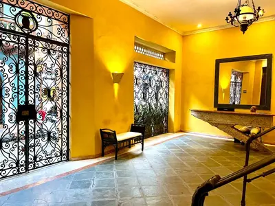 a room with a door with a bench and a mirror at by Calamari Homes - El Porvenir 306 walled city in Cartagena de Indias