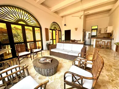 a living room with a couch and a table and chairs at by Calamari Homes - El Porvenir 306 walled city in Cartagena de Indias