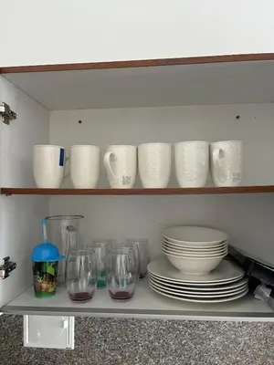 a shelf with plates and cups and glasses on it at Edificio K in Cartagena de Indias
