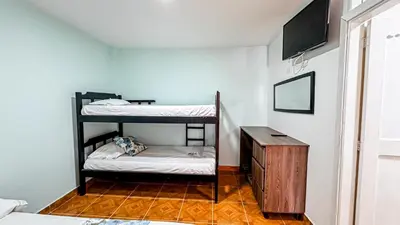 a room with two bunk beds and a table at Hotel Santiago de Tolú in Santiago