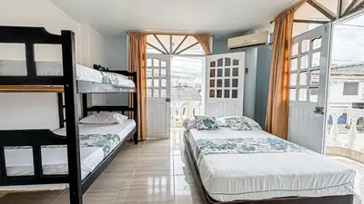 a bedroom with two bunk beds and a window at Hotel Santiago de Tolú in Santiago