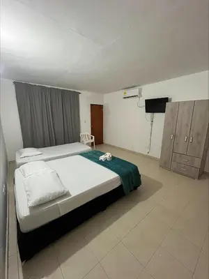 a bedroom with a bed and a television in it at Stay Mar y Playa House in Cartagena de Indias