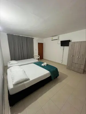a bedroom with a bed and a television in it at Stay Mar y Playa House in Cartagena de Indias