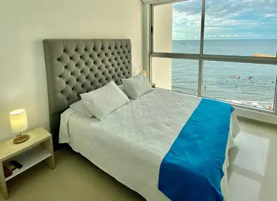 a bedroom with a large bed with a view of the ocean at Confort Total con Vista al Mar 11 in Cartagena de Indias